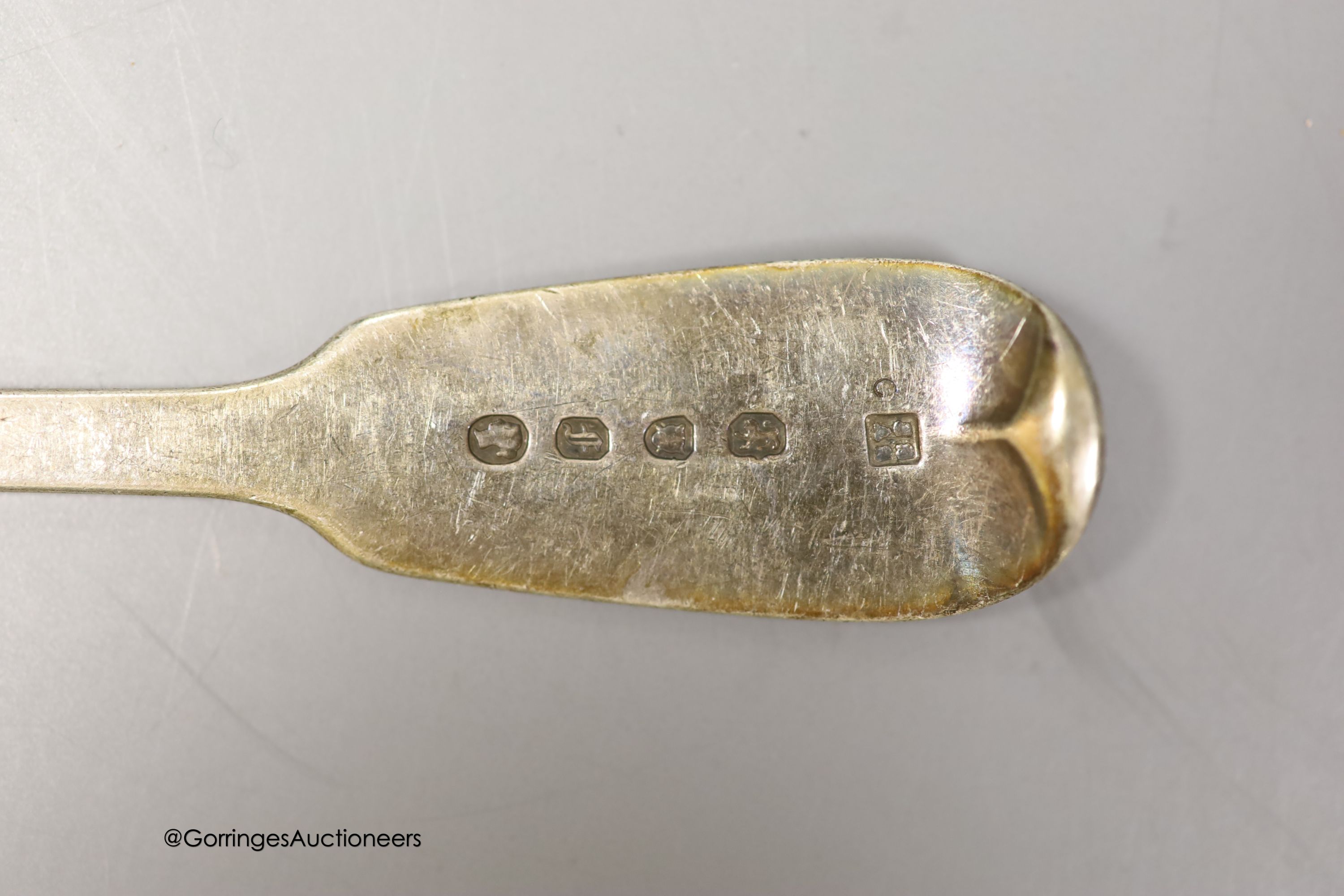 Nine items of assorted 19th century and later silver flatware and a silver 'Whiskey' wine label, 9.5oz.